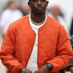 Damson Idris F1 The Movie 2025 orange jacket